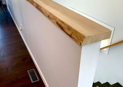 A picture of an elm cap wall divider along basement stairs.