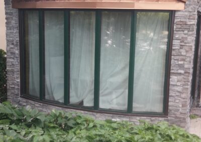 Exterior grey stone displayed around front window.